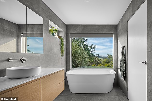 The bath in the main bathroom is deep and luxurious and has a great view