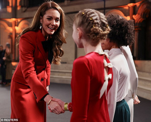 The royal mother of three greets children performing at Westminster Abbey for her Christmas carol concert