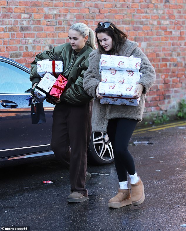 Molly opted for minimal makeup for the outing and looked somber as she carried boxes covered in Christmas wrapping and a Chanel gift bag