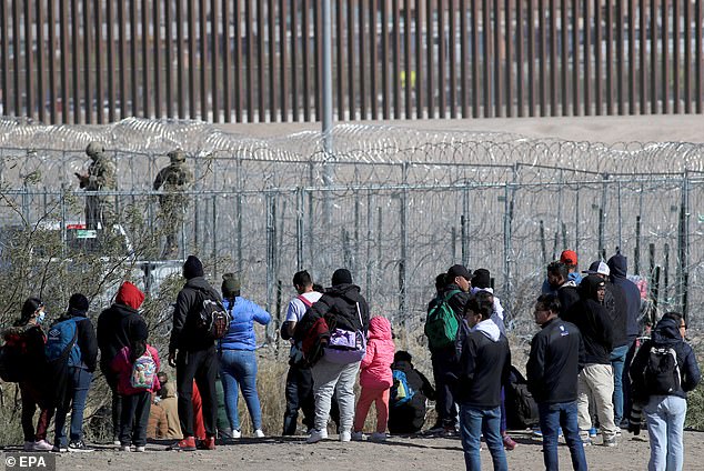 A group of migrants wait at a border point in Juarez City, Chihuahua, Mexico, December 18, 2024. On International Migrants Day, the Texas National Guard fired pepper balls to disperse a group of more than 150 migrants, mostly from Central and South America. who were tricked on social networks into thinking they would be allowed to pass through the border wall in northern Mexico