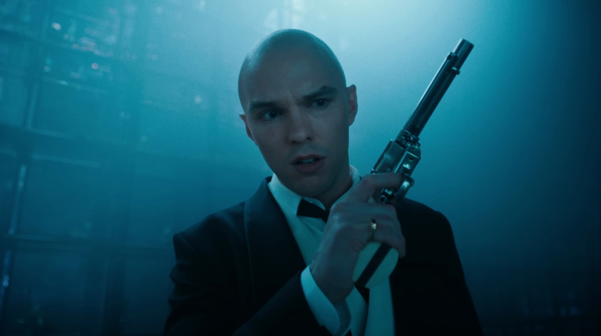 Nicholas Hoult holds a gun as Lex Luthor in Superman 2025