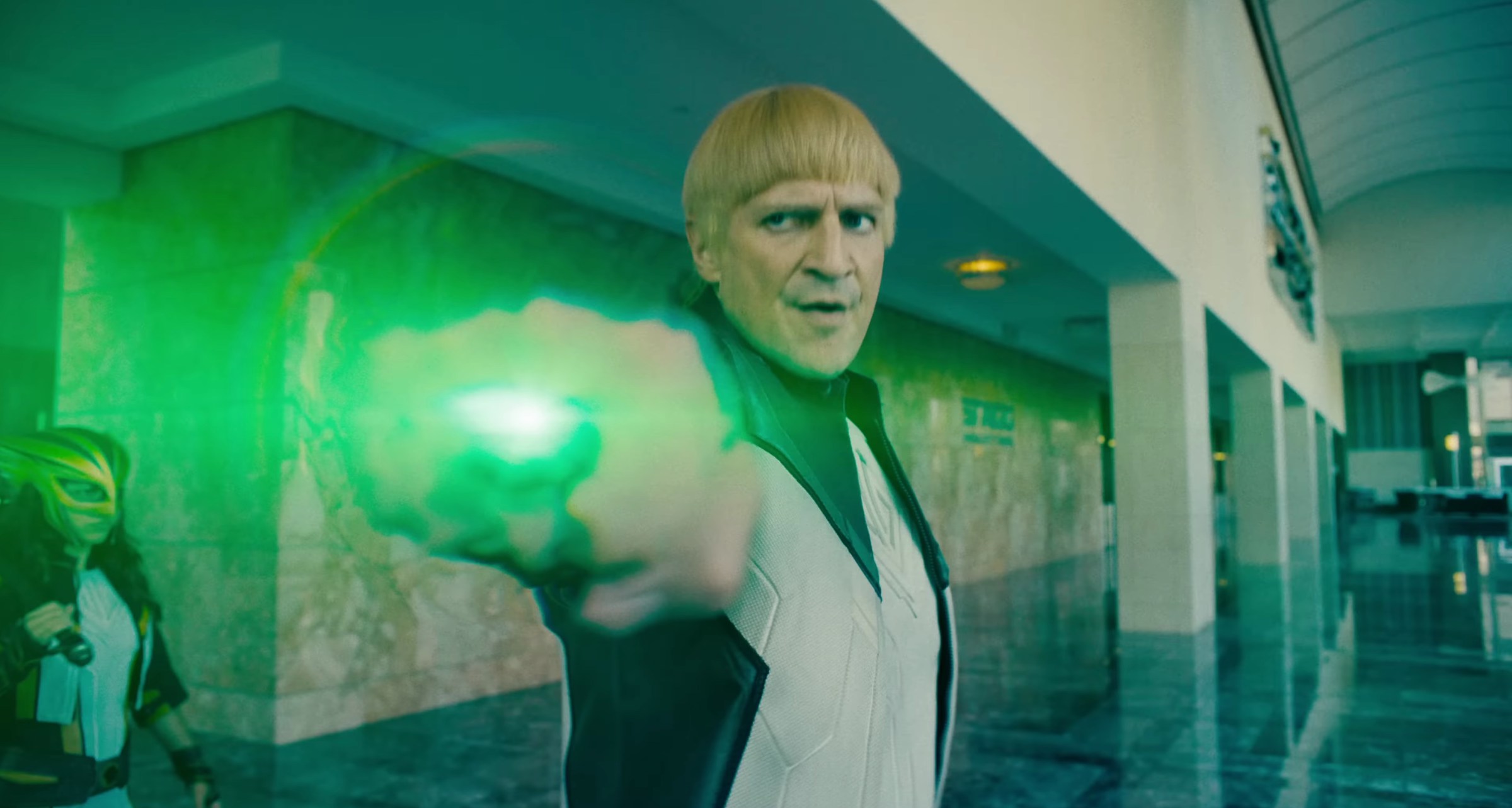 Guy Gardner (Nathan Fillion with a bowl cut) powers his Green Lantern ring in Superman 2025