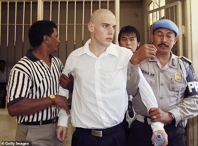 Norman, the youngest member of the Bali Nine, was only 18 years old when he was arrested. In the photo he is accompanied to his sentencing trial in Bali in 2006