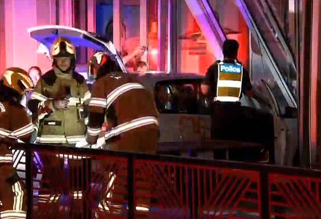 Emergency services are pictured at the scene at a Nando's on Barkly Street in Footscray in inner-city Melbourne, where a car was rammed through the front of the restaurant at 2.15am on Friday