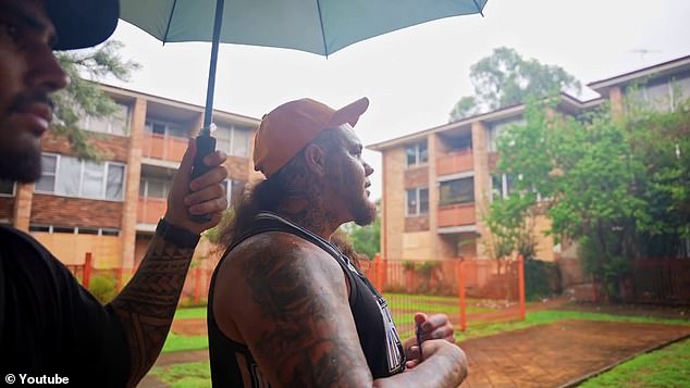 A local resident calling himself Caleb shows the brothers around a dilapidated apartment building