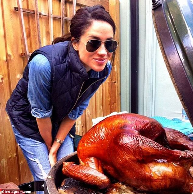 Meghan, Duchess of Sussex, pictured smiling with a turkey