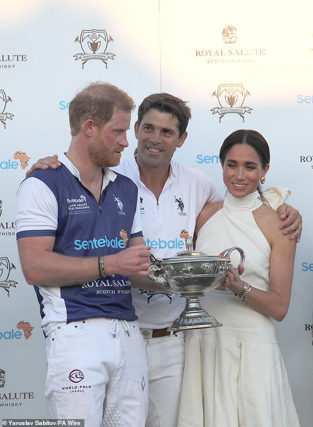 Meghan presents her husband with a trophy during a polo match in April