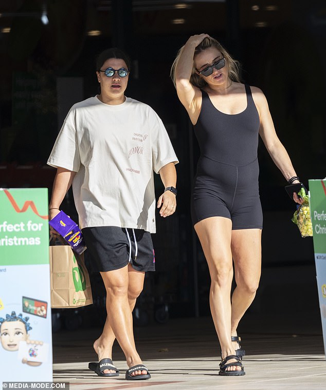 Sam was seen eagerly chatting with her partner Kristie, who showed off her blossoming baby bump in a form-fitting black unitard