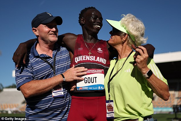 Gout Gout is celebrating with his manager James Templeton and coach Di Sheppard