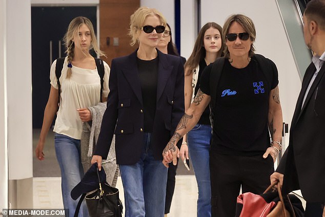 They were accompanied by their two teenage daughters Sunday and Faith, who were walking close behind them after getting off their long-haul flight.