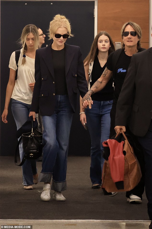 The family all looked as close as ever as they stepped off the plane after their long journey from the United States