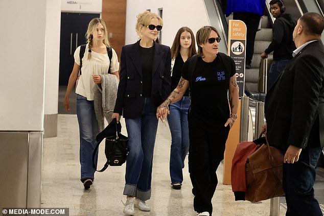 Nicole smiled as they caught the attention of other travelers after landing in Australia