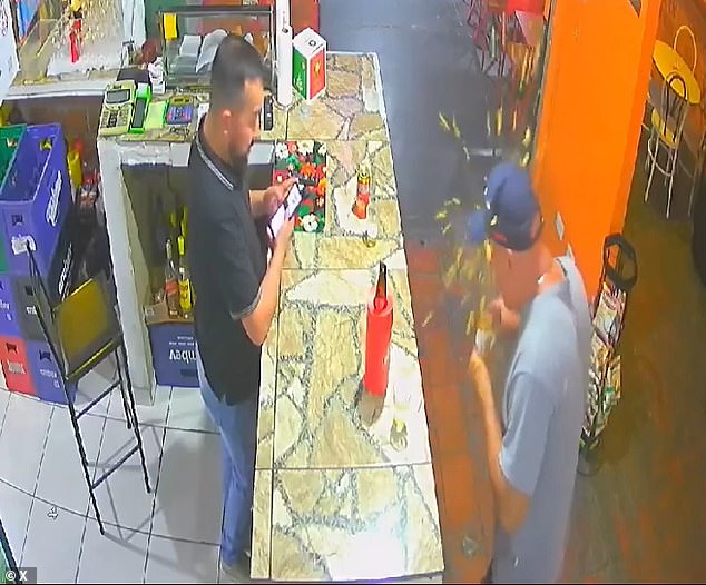 Bar owner Christian Amaral (right) said in an interview with CNN Brasil that the chicken snack was removed from the oven and handed to the customer (left) before it suddenly exploded and burned his face