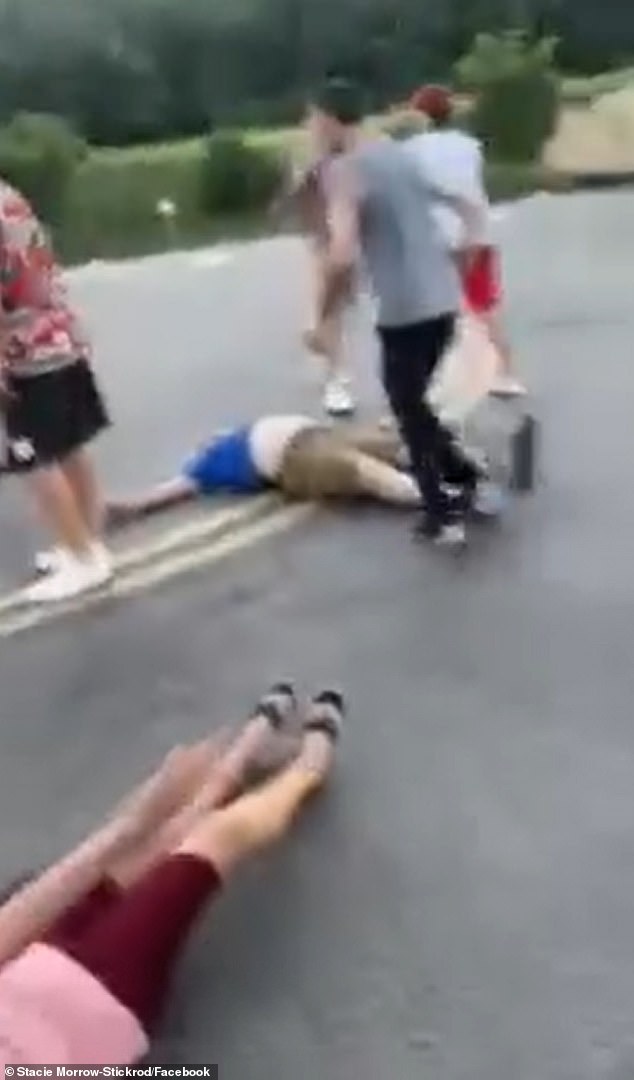 Douglas Morrow, 79, is pictured in a blue shirt and cargo shorts, lying on the sidewalk. His wife Lois can also be seen on the ground at the bottom left