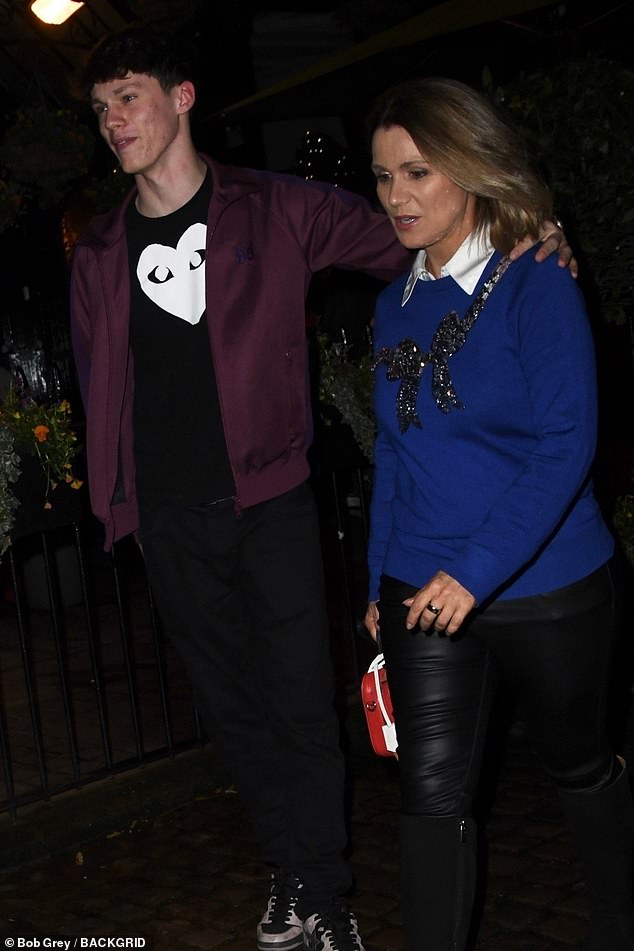 Susanna carried her essentials in a red mini handbag as she put on an animated display as she left the party with her son