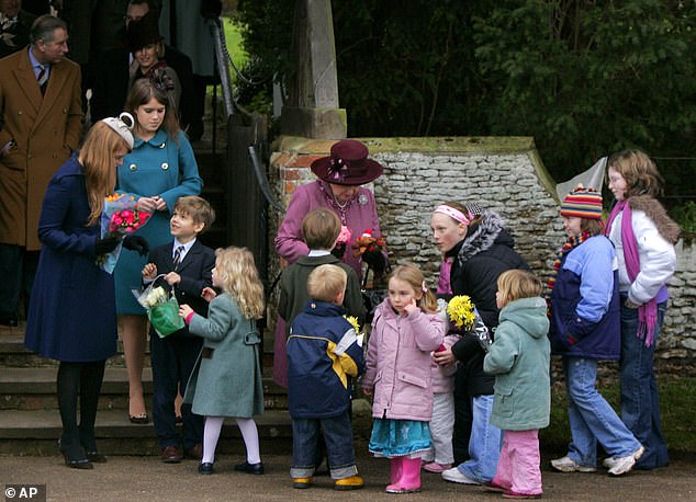 Queen Elizabeth II receives flowers from young children after attending the traditional church service on Christmas Day in 2006