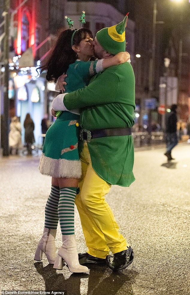 CARDIFF: A woman hugs her Christmas elf in Cardiff city centre