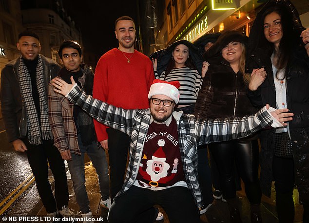 LEEDS: There's Christmas cheer everywhere as a man wearing a Santa hat (front) expresses his festive joy