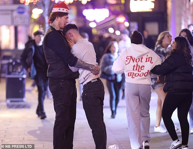 LEEDS: Others weren't feeling so festive as someone cries into the chest of a tall man in a Santa hat