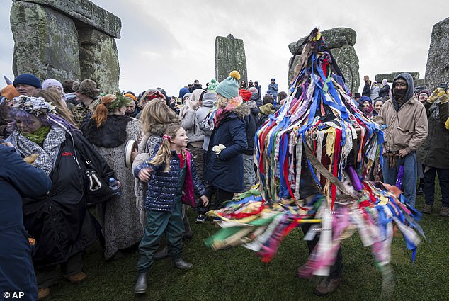 A hobbyhorse, decked out in ribbons, performs today at the winter solstice celebrations at Stonehenge