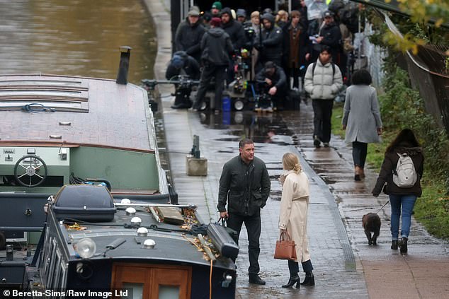 She later swapped the ensemble for a tan coat and swept her blonde locks back into a neat bun as she toted around a brown handbag.