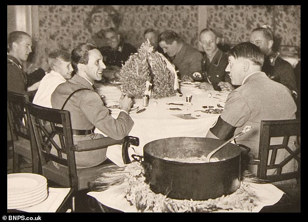 Hitler, right, is seen talking to his propaganda minister Joseph Goebbels during a dinner in the Führerbunker