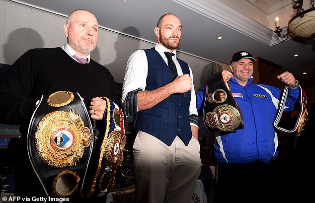 Peter (left), with Tyson and his father John (right) at a press conference in Bolton in 2015