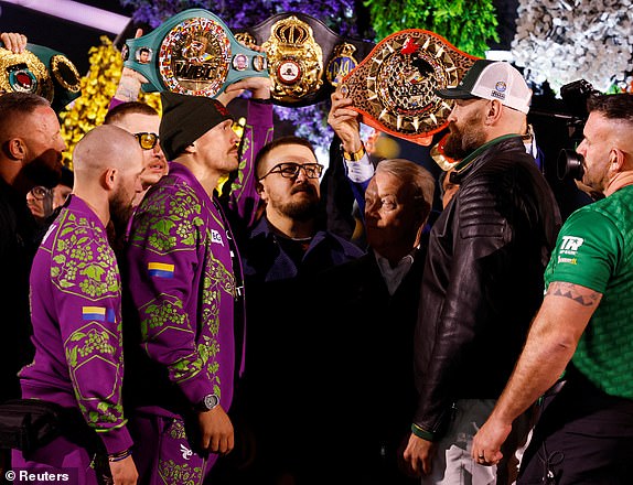 Boxing - Oleksandr Usyk vs. Tyson Fury - World Heavyweight Title - Weigh-in - Kingdom Arena, Riyadh, Saudi Arabia - December 20, 2024 Oleksandr Usyk and Tyson Fury face off during the weigh-in REUTERS/Hamad I Mohammed TPX IMAGES OF THE DAY