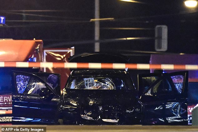 Forensic police inspect the car that rammed into a crowd at a Christmas market in Magdeburg, East Germany, on December 21, 2024