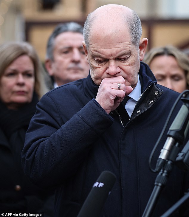 Chancellor Scholz arrived to pay his respects at the market, where he described last night's event as a 'terrible, insane act'