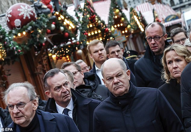 Scholz (second from right) is accompanied by German Justice Minister Volker Wissing (second from left) and German Environment Minister Steffi Lemke (right)