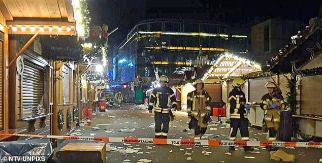 Firefighters patrolled the scene of an accident on Friday after a car plowed into a huge crowd of shoppers at a Christmas market in Magdeburg at around 7pm.