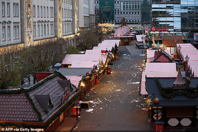 Debris and closed stalls are seen at the scene of a car ram attack at a Christmas market in Magdeburg