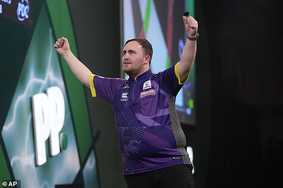 FILE - Luke Littler of England celebrates after winning the semi-final against England's Scott Williams at the World Darts Championship in London, Tuesday, Jan. 2, 2024. (AP Photo/Kin Cheung, File)