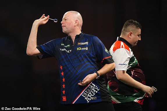 Raymond van Barneveld in action during his second round match against Nick Kenny (right) on day seven of the Paddy Power World Darts Championship at Alexandra Palace, London. Date of photo: Saturday, December 21, 2024. PA Photo. See PA story DARTS World. Photo credit should read: Zac Goodwin/PA Wire. RESTRICTIONS: Use subject to restrictions. Editorial use only, no commercial use without prior permission from the rights holder.