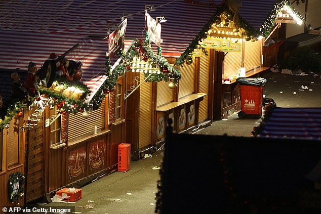 Debris and empty stalls are seen at a closed Christmas market a day after a car ram attack in Magdeburg