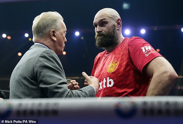 Fury was consoled by Frank Warren (left) in the ring after the decision was announced