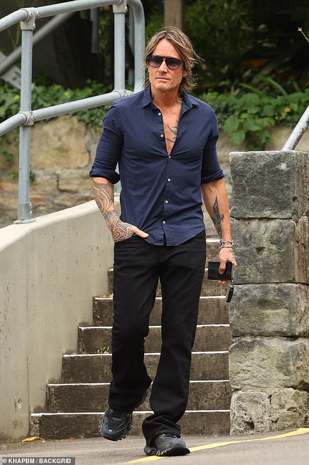 Her husband Keith also looked stylish for the church service in a navy blue shirt and black trousers