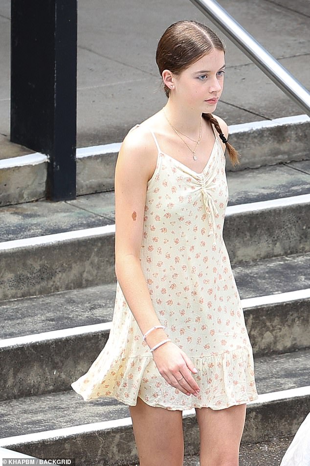 Faith wore a light summer dress with floral print, spaghetti straps and a ruffled neckline