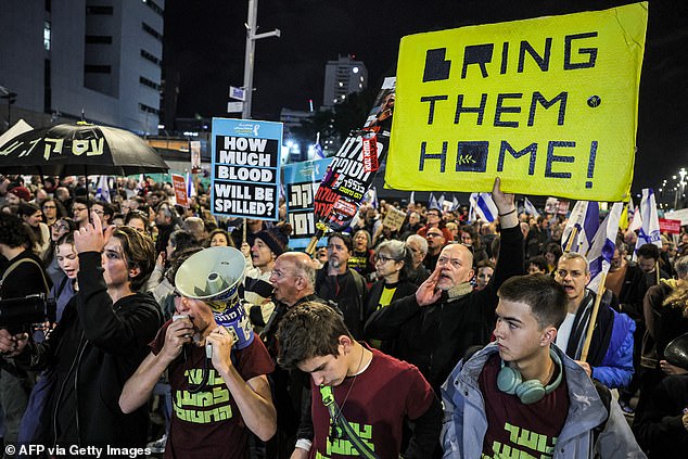 Protesters beat drums during an anti-government protest calling for action to secure the release of Israeli hostages held since the October 7 attacks by Palestinian militants in the Gaza Strip, outside the Israeli Defense Ministry headquarters in Tel Aviv on December 21, 2024