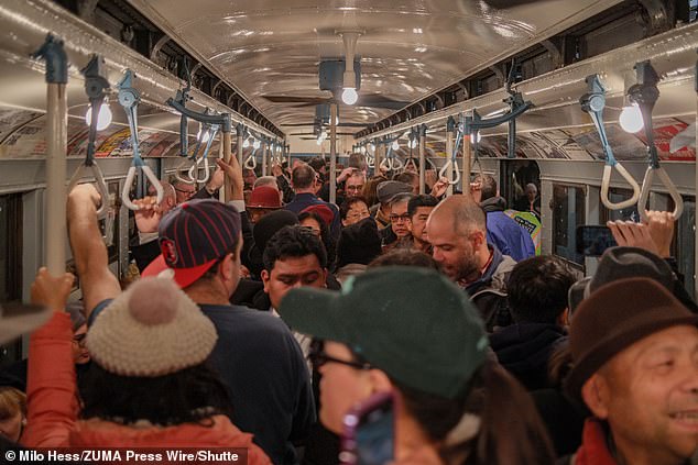 The New York Transit Museum offers Sunday rides during the Christmas holidays. Straphangers are depicted on the train enjoying the nostalgic 1930s holiday ride