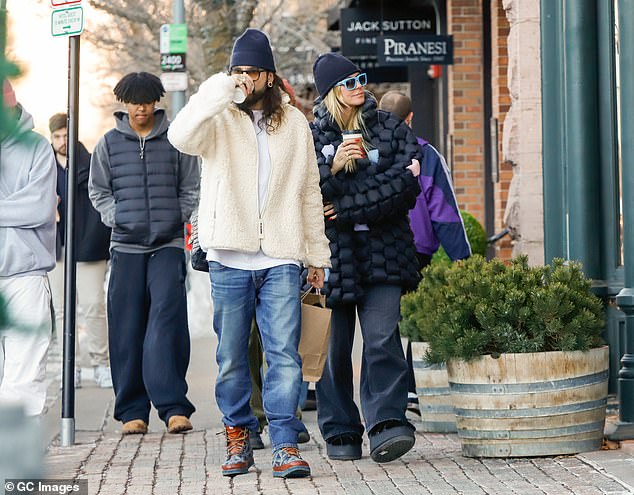 The guitarist added a pair of sturdy snow boots to his outfit and was later spotted wearing a black beanie