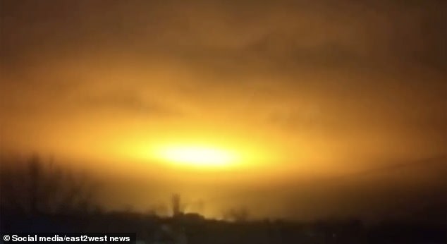 Video showed the sky lighting up in vibrant apocalyptic yellow and orange colors as air defenses tried to defend the strategic oil depot