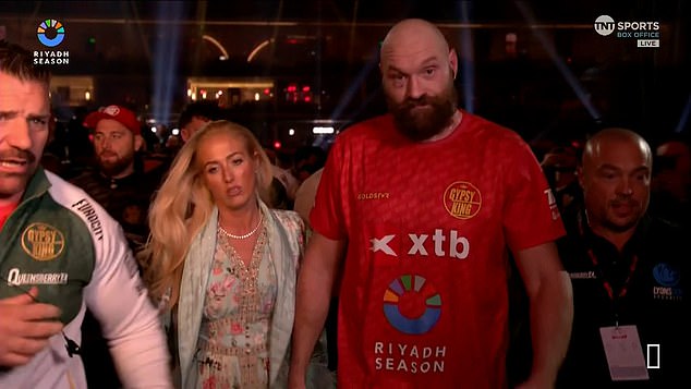 As he stormed out of the ring without conducting a post-fight interview, he was comforted by Paris, who stood next to her dejected husband as the pair returned to his dressing room.