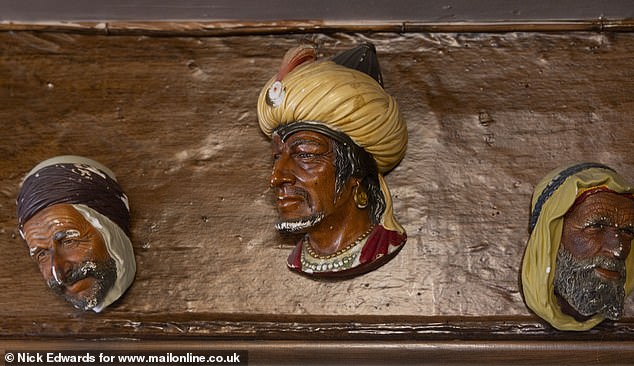 In a corner of the pub in Kings Langley, with its oak beams and low ceilings, is a fireplace with half a dozen Saracen head ornaments.