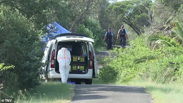 Pictured: Forensic officers examine the site where the bodies of a couple were uncovered