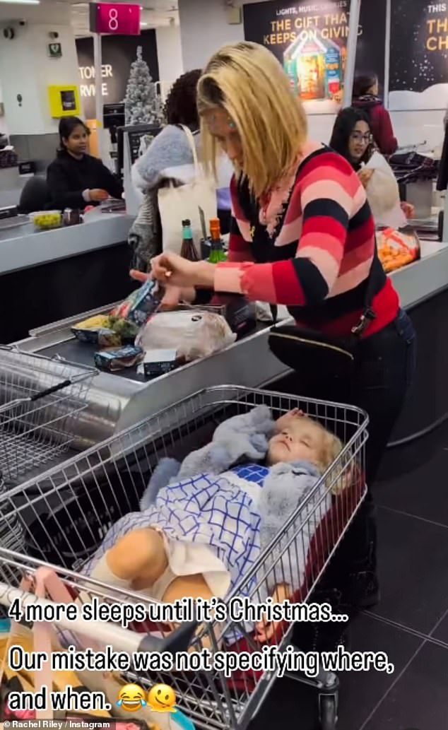 Rachel laughed as she piled the items on the cash register, while Noa continued to sleep in the shopping cart