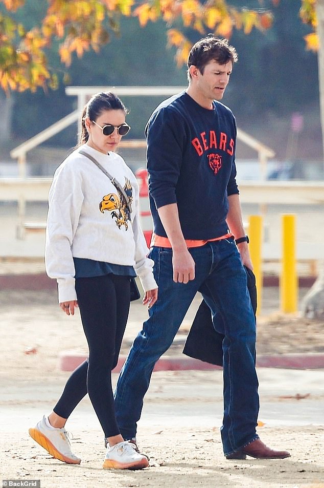 The That 70s Show stars were dressed casually, with Mila, 41, wearing black leggings and a white sweatshirt with an eagle on the front, while Ashton wore a Chicago Bears sweatshirt, jeans and brown leather boots.