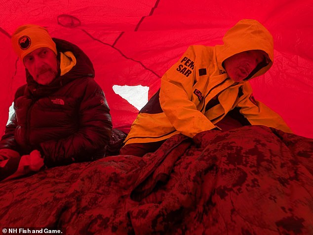 Rescuers on the ground provide aid to stricken hiker Patrick Bittman in a lightweight emergency shelter, known as a Bothy Bag, during a search and rescue operation on Franconia Ridge