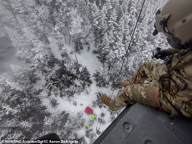 A stunning view from just 75 feet sees Sgt. Daniel Bourque, a medevac crew member with the New Hampshire Army National Guard, demotes Sgt. 1st Class Ethan Major to save Patrick Bittman